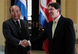 DPRK's Foreign Minister Pak Ui Chun, left, shakes hands with Cuba's Foreign Minister Bruno Rodriguez at the Foreign Ministry in Havana, Monday, May 4, 2009.(AP Photo/ Ismael Francisco, Prensa Latina)