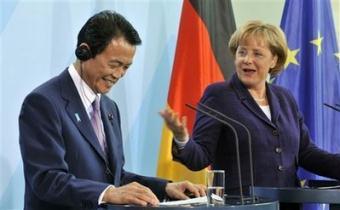 German Chancellor Angela Merkel, right, and Japanese Prime Minister Taro Aso, left, address the media during a news conference in Berlin, Germany, on Tuesday, May 5, 2009. Aso is on a one-day visit to Germany.(AP Photo/Gero Breloer)