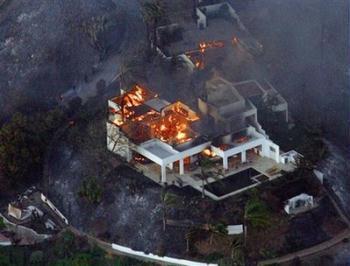 California wildfires burn structures and hillsides in Santa Barbara, Calif., on Wednesday, May 6, 2009. Fierce winds blew a wildfire into Southern California homes Wednesday, forcing thousands of people to flee and detroying mansion and humble homes.