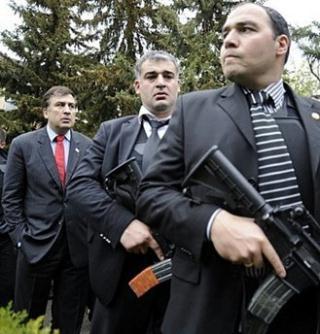 Georgian&nbsp;President&nbsp;Mikheil&nbsp;Saakashvili&nbsp;(L)&nbsp;guarded&nbsp;by&nbsp;bodyguards&nbsp;at&nbsp;the&nbsp;Mukhrovani&nbsp;military&nbsp;base&nbsp;some&nbsp;10km&nbsp;outside&nbsp;of&nbsp;Tbilisi&nbsp;on&nbsp;May&nbsp;05.&nbsp;NATO&nbsp;on&nbsp;Wednesday&nbsp;began&nbsp;controversial&nbsp;military&nbsp;exercises&nbsp;in&nbsp;Georgia&nbsp;a&nbsp;day&nbsp;after&nbsp;the&nbsp;ex-Soviet&nbsp;republic&nbsp;said&nbsp;it&nbsp;had&nbsp;put&nbsp;down&nbsp;a&nbsp;military&nbsp;rebellion&nbsp;that&nbsp;had&nbsp;Russia's&nbsp;backing.(AFP/File/Irakli&nbsp;Gedenidze)