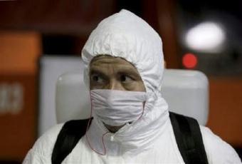 A worker in a protective suit prepares to disinfect the interior of a train carriage to prevent the spread of the Influenza A (H1N1) virus, formerly referred to as swine flu, at the Constitucion de 1917 subway station in Mexico City May 7, 2009.REUTERS/Daniel Aguilar