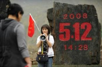 A tour guide speaks to tourists at the Donghekou Earthquake Site Park in Qingchuan County in China's southwest Sichuan province.