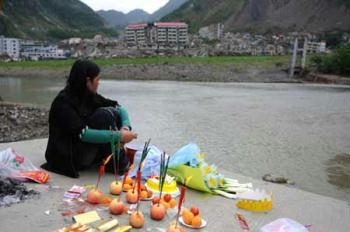 A mother mourns for her child who was only 67 days old when killed in last year's May 12 earthquake in Beichuan, the hardest-hit area in the disaster, in southwest China's Sichuan Province, on May 10, 2009. Parents who lost their children came back to Beichuan as the first anniversary of the disaster approaches. (Xinhua/Jiang Hongjing)