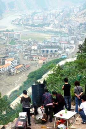 People commemorate victims of the May 12 earthquake last year, outside Beichuan city, which was seriously damaged in the earthquake, southwest China's Sichuan Province, May 10, 2009. As the first anniversary of the earthquake approaches, people all over China commemorate the disaster in different ways. (Xinhua Photo)