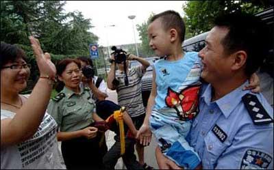 Lang Zheng (2nd R), known as the "Salute Boy", leaves Tangdu Hospital after two months of treatment, in Xi'an, capital of northwest China's Shaanxi Province, July 27, 2008. Lang, from the Qushan Township Kindergarten of Beichuan Qiang Autonomous County in southwest China's Sichuan Province, was rescued from the debris after the May 12 Wenchuan earthquake. After being put on a stretcher, the injured and fragile boy slowly raised his right hand and saluted his rescuers in gratitude. The moment was captured by a photographer and moved the whole nation. His fractured left arm and partly amputated left fingers have been recovering well during the two months at Tangdu Hospital.