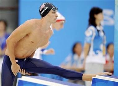 US swimmer Eric Shanteau stretches on the starting block before his semi-final race in the men's 200 meters breaststroke during the swimming competitions in the National Aquatics Center at the Beijing 2008 Olympics in Beijing, Wednesday, Aug. 13, 2008. The American swam a personal best in Wednesday's semifinals of the 200-meter breaststroke but it wasn't enough to advance to Thursday's final. The 24-year-old swimmer will now return to Atlanta for surgery on the testicular cancer he was diagnosed with a few weeks before last month's U.S. trials.(AP Photo/Mark J. Terrill)