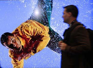 A visitor walks past Sharp booth at the annual Las Vegas Consumer Electronics Show (CES) held in Las Vegas, Nevada State of the United States, on Jan. 9, 2009. Some 2,700 exhibitors will tout their latest innovations at the four-day show, which opened on Thursday in Las Vegas.(Xinhua/Zhang Yan)
