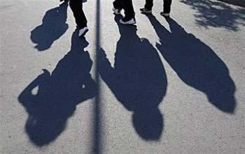 Patients cast a shadow while walking to lunch at a weight reduction clinic. Simply being overweight, but not obese, from an early age boosts the risk of premature death by a third -- as much as smoking up to 10 cigarettes a day, researchers in Sweden reported Wednesday.[Agencies]