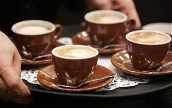 Rich Westerfield, the owner of Aldo Coffee Company serves his cappuccinos to the judges in the Northeast, Mid-Atlantic Region Barista Competition in Cranberry, Pa., Friday, Feb. 6, 2009.[Agencies]