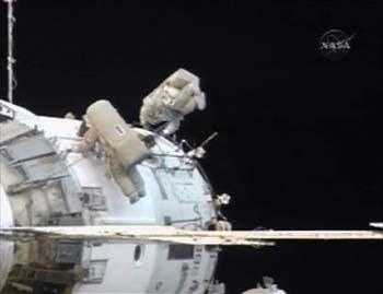 International Space Station (ISS) Commander Mike Fincke (L) and Flight Engineer Yury Lonchakov work outside the Russian segment of the station during their spacewalk from the orbiting laboratory in this March 10, 2009 image from NASA TV. Dressed in Russian spacesuits, Fincke and Lonchakov floated outside the orbiting outpost for six hours of work, including setting up a European materials science experiment, before the shuttle Discovery's scheduled arrival on Friday. (Xinhua/Reuters, File Photo)