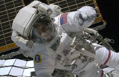 Space shuttle Discovery crew member Steven Swanson works outside the international space station during a space walk orbiting Earth, Thursday, March 19, 2009. Astronauts aboard the U.S. space shuttle Discovery unfurled the International Space Station's fourth and final set of solar array wings, bringing the 10-year-old space station to full power, which is critical for boosting science research and allowing the crew to double to six.(Xinhua/AFP Photo)