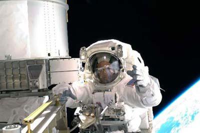Space shuttle Discovery crew member Richard Arnold works outside the international space station during a space walk orbiting Earth, Thursday, March 19, 2009. Astronauts aboard the U.S. space shuttle Discovery unfurled the International Space Station's fourth and final set of solar array wings, bringing the 10-year-old space station to full power, which is critical for boosting science research and allowing the crew to double to six. (Xinhua/AFP Photo)
