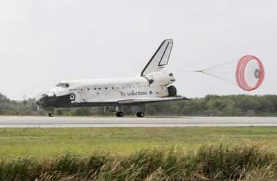 The space shuttle Discovery has its drag parachute deployed as it rolls past the runway convoy after it returned to earth at the Kennedy Space Center in Cape Canaveral, Florida March 28, 2009. The landing ends Mission STS-119 to the International Space Station. (Xinhua/Reuters Photo)