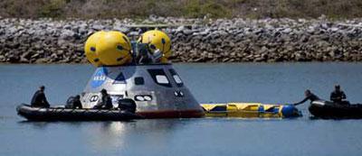 Parajumpers from the Air Force 920th rescue wing remove a flotation collar from a full-size mockup of NASA's crew module for the Orion Crew exploration vehicle at the Cape Canaveral Air Force Station in Cape Canaveral, Florida, April 8, 2009. The Orion spacecraft will become the primary U.S. vehicle for human space exploration after the retirement of the space-shuttle fleet in 2010. (Xinhua/Reuters Photo)