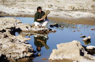 Gustavo Lara, Director of Culture of the town of Roque Perez, holds a fossil bone of a megatherium, a kind of large ground sloth, at an excavation site on the outskirts of Roque Perez, some 135 km (84 miles) south of Buenos Aires, May 6, 2009. Fossil bones of nine glossopteris, a glyptodont, the nearly complete skeleton of a megatherium and a head of a stegomastodon dated from the Pleistocene, the epoch from 1.8 million to 10000 years ago, were found by paleontologists in the sediments of the Salado River due to a drought that has been affecting the area for months, local media reported. (Xinhua/Reuters Photo)